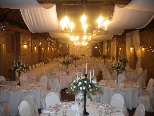 Wedding Venue stylists offerring chair coversfairy light backdrops and 