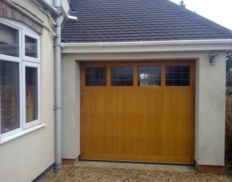 Cedar Garage Door timber Sectional fully finished in light oak with diamond lead windows