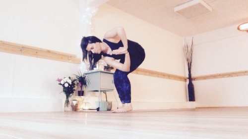 Chair pose with a twist. Something you might find in one of our yoga classes. A detoxing, energising pose.