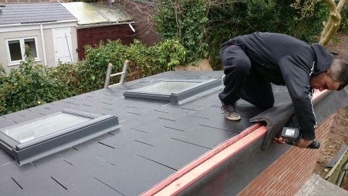 Slate tiled roof with VELUX roof windows on a new home extension.