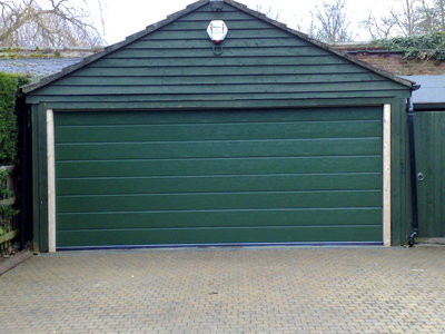 Doco grooved Sectional Garage Door in bespoke green